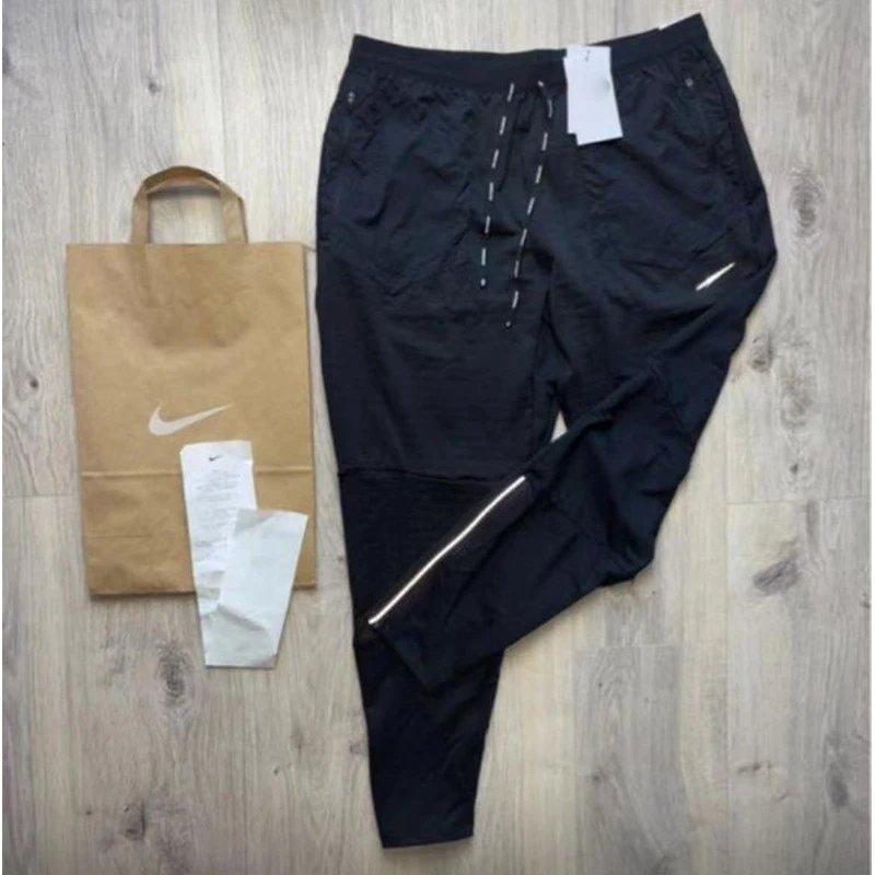 Nike Black Woven Track Pants with Reflective Stripe and Zippered Pockets