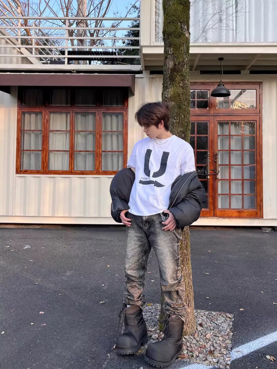 White Graphic Tee with Distressed Jeans and Boots
