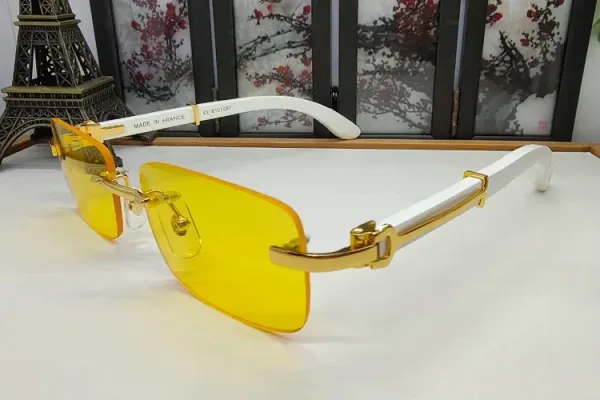 Design Rimless Yellow Tinted Sunglasses with White and Gold Accents Eyewear - 1