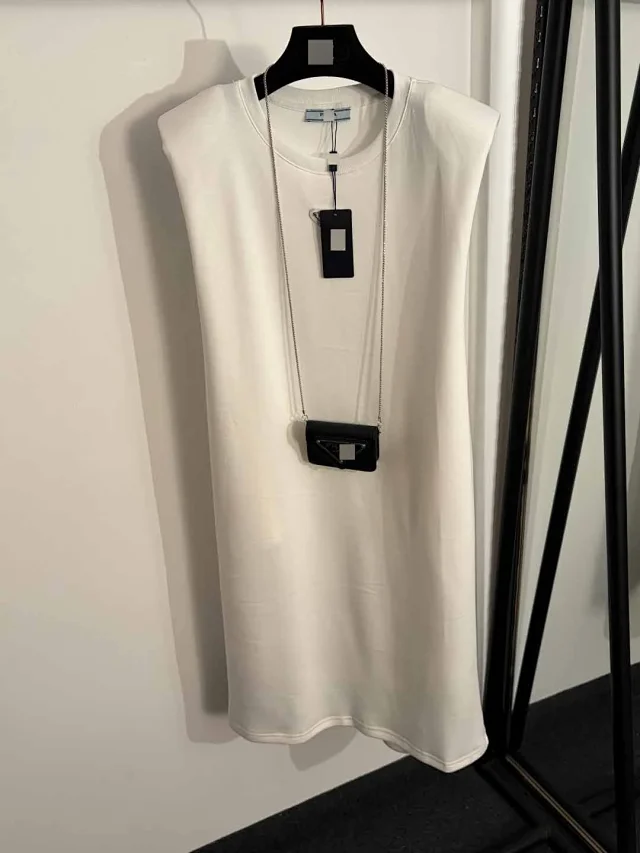 Prada Dresses Sleeveless padded-shoulder dress with triangle plaque and chain mini bag product detail image 2