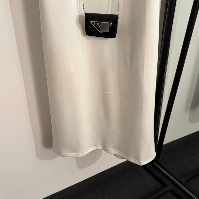 Prada Dresses Sleeveless padded-shoulder dress with triangle plaque and chain mini bag product detail image 5