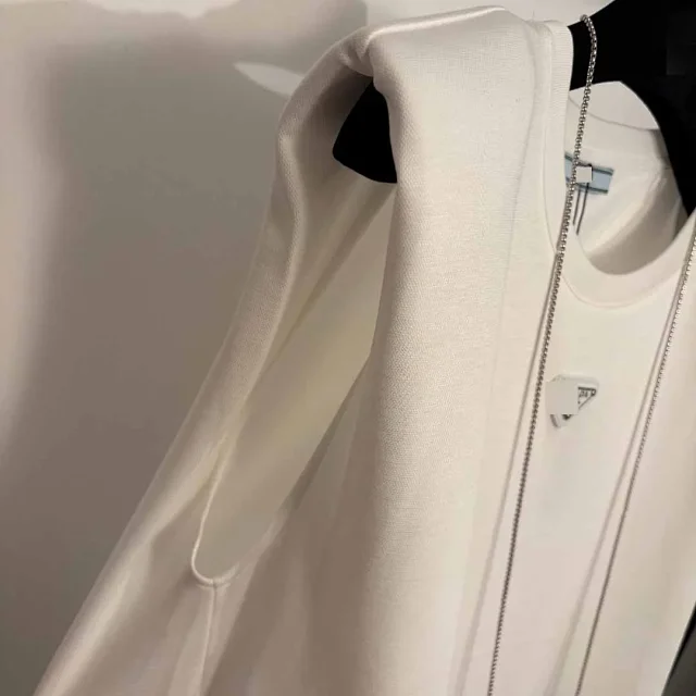 Prada Dresses Sleeveless padded-shoulder dress with triangle plaque and chain mini bag product detail image 6