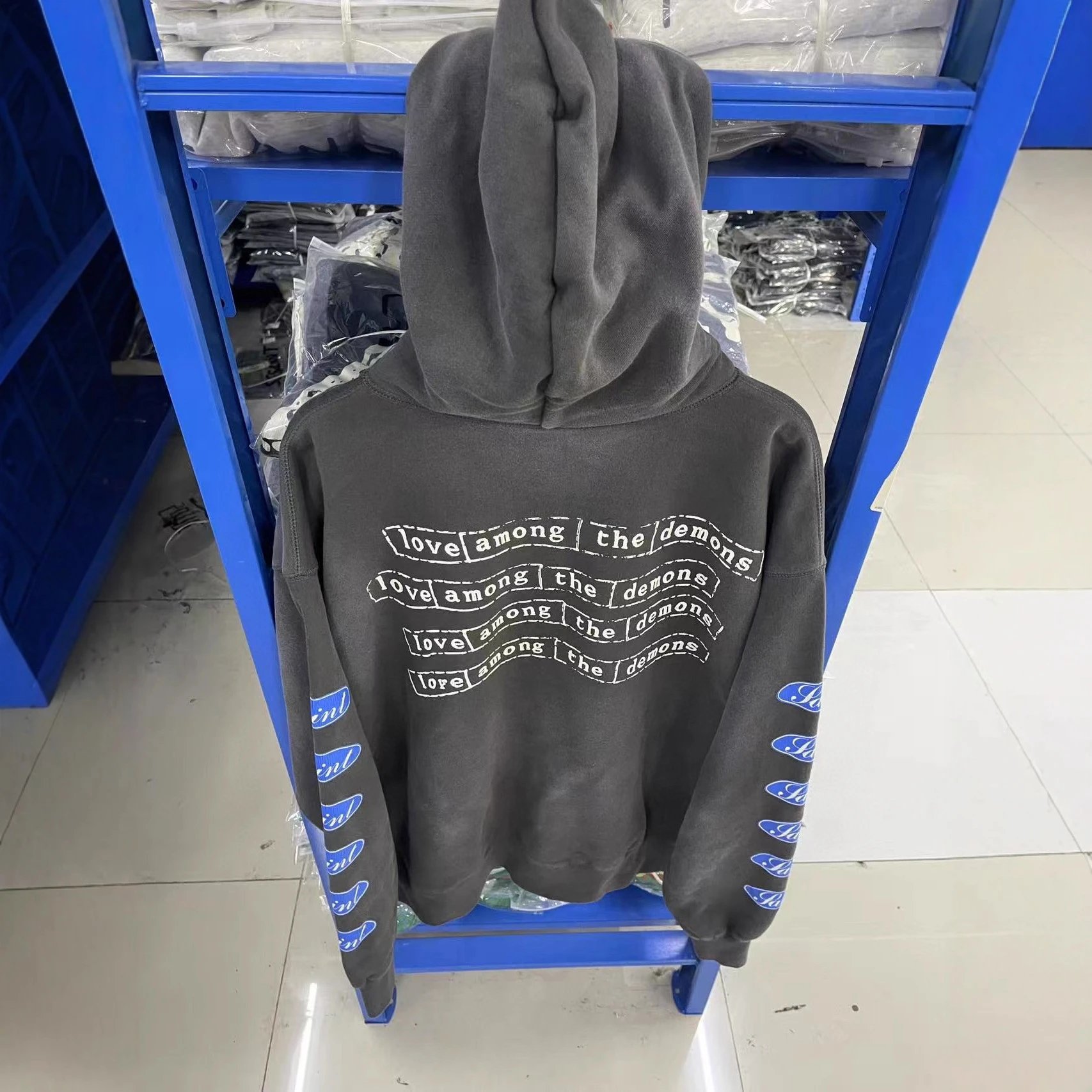 Gray Hooded Sweatshirt With 'Love Among The Demons' Print And Blue Logo Sleeves