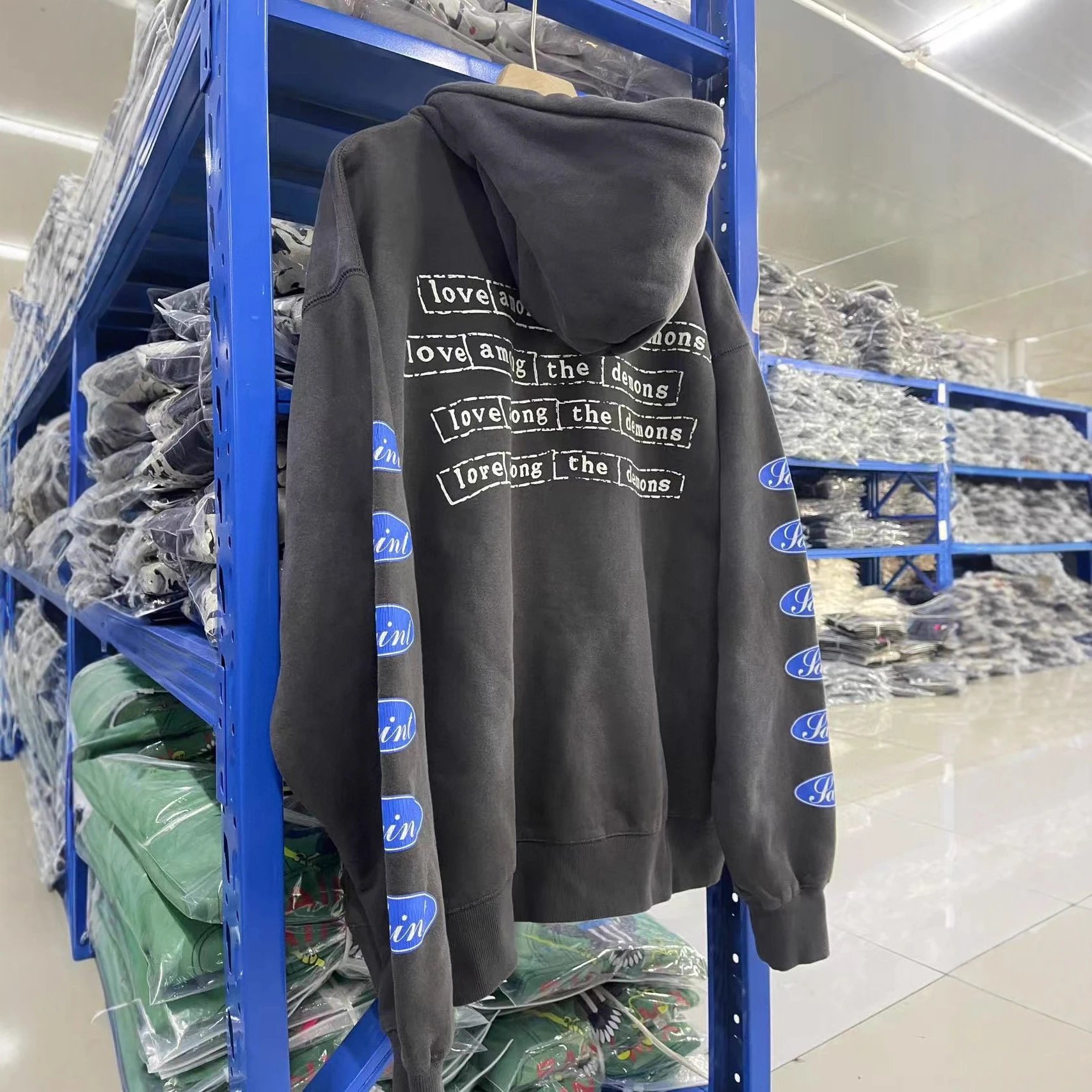 Gray Hooded Sweatshirt With 'Love Among The Demons' Print And Blue Logo Sleeves