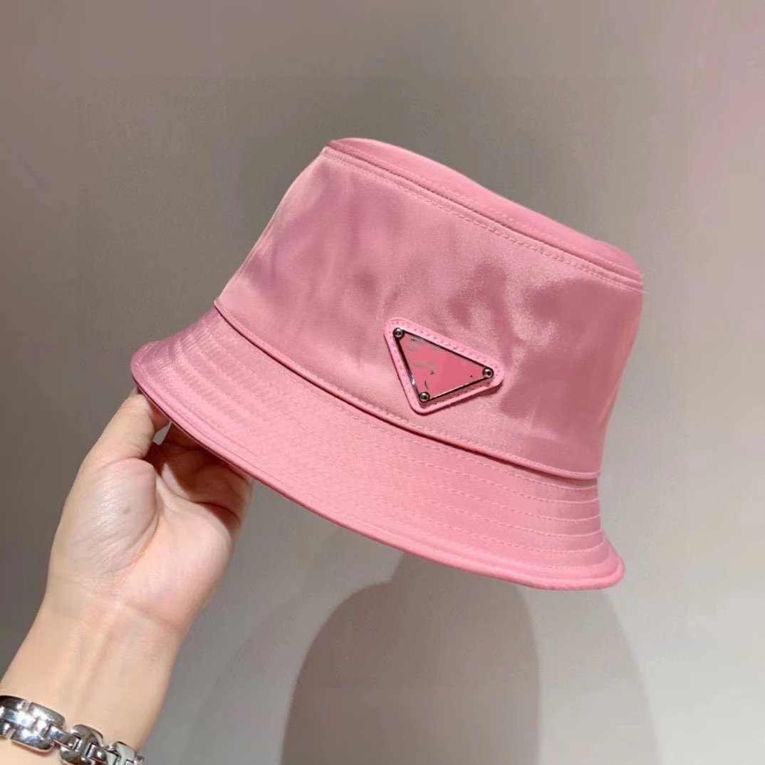 Prada Hats Nylon bucket hat with triangle logo plaque — Pink