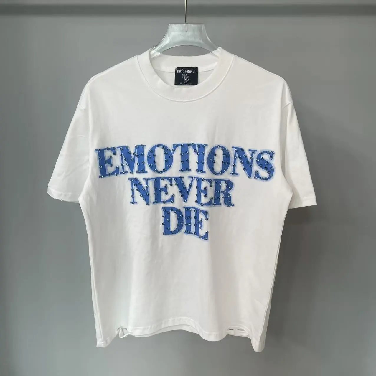 Mixed Emotion T-Shirts Rhinestone Emotions Never Die Graphic — White and blue