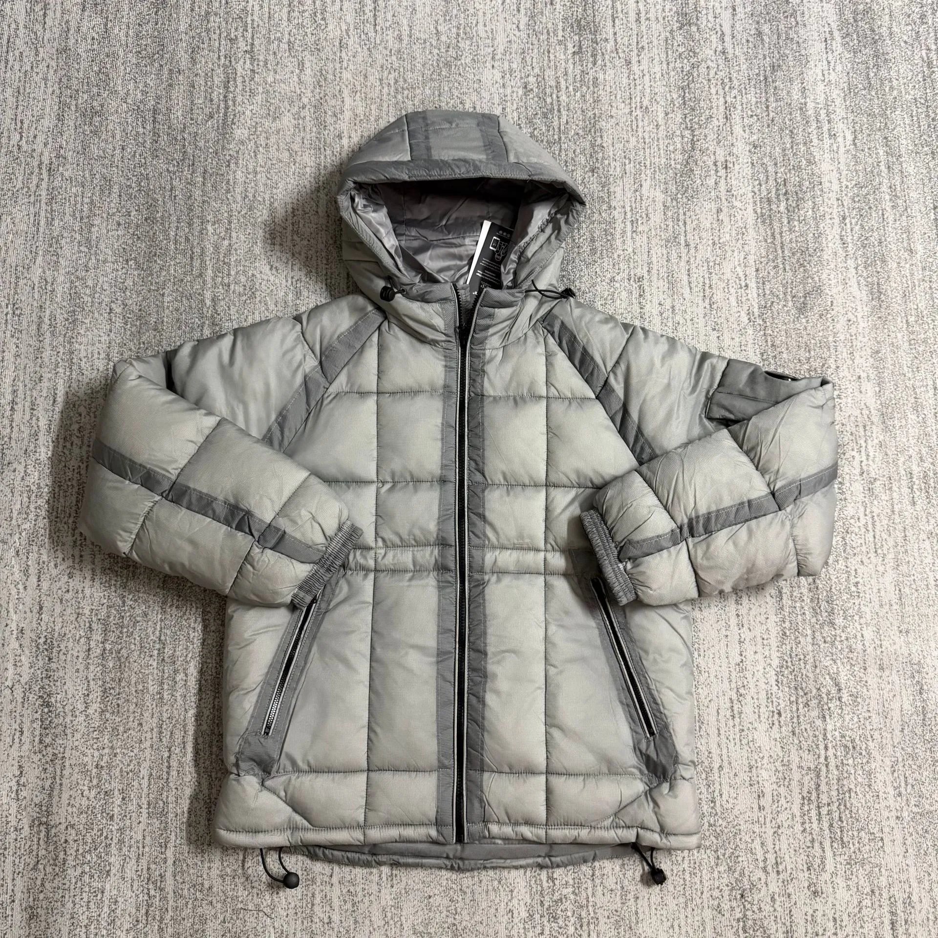 C.P. Company Jackets Hooded quilted puffer jacket with lens sleeve detail — gray