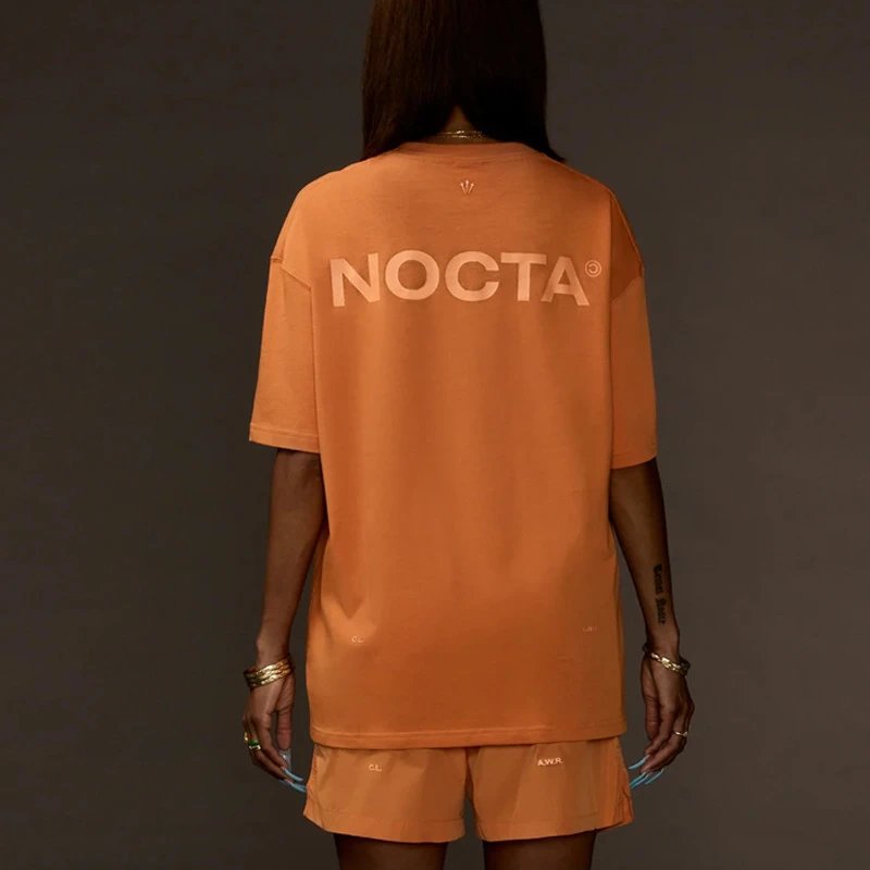 NOCTA T-Shirts Logo Print Short-Sleeve T-Shirt — Orange