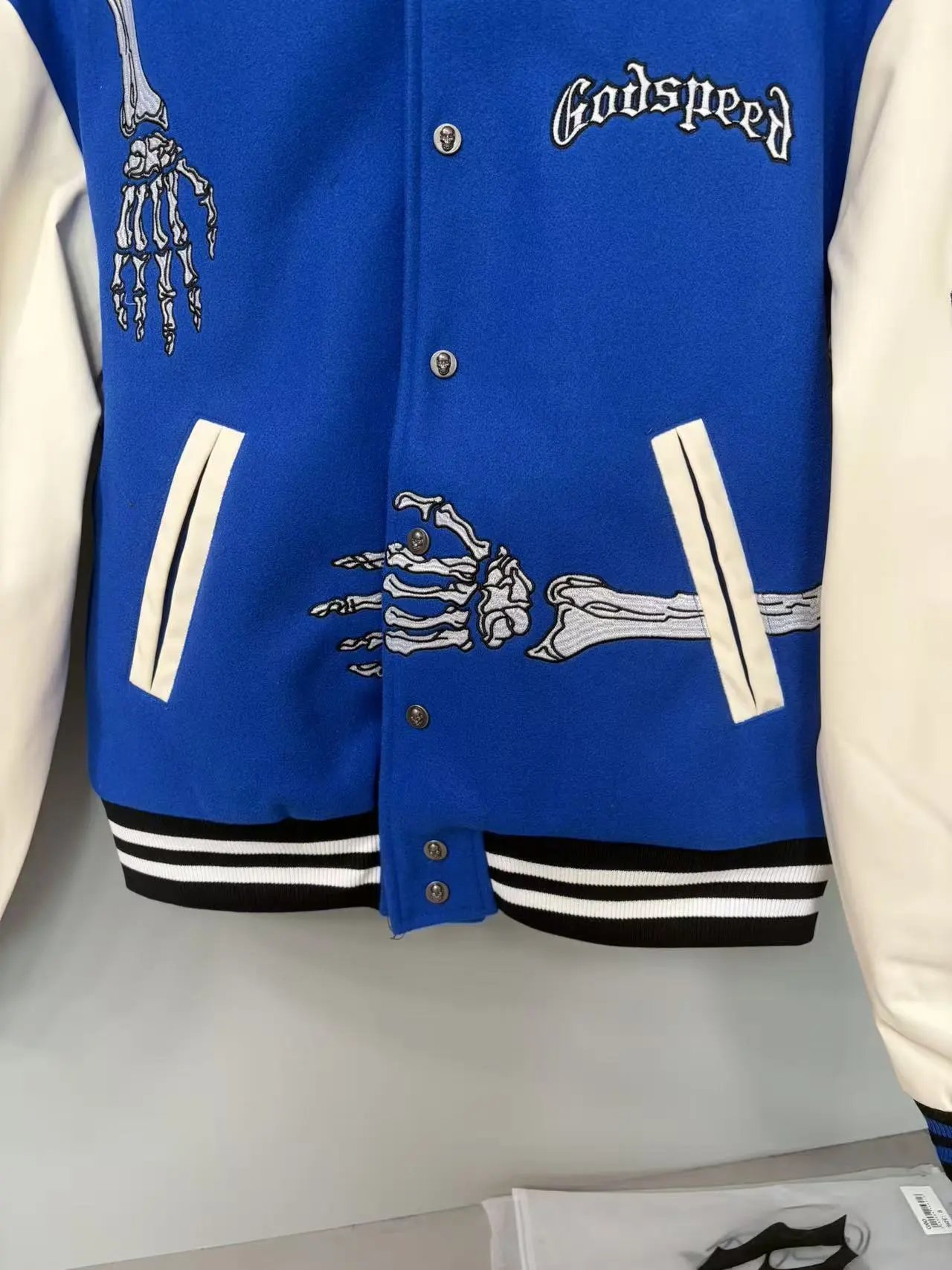 Blue Varsity Jacket with Embroidered Skeleton Design Cream Sleeves