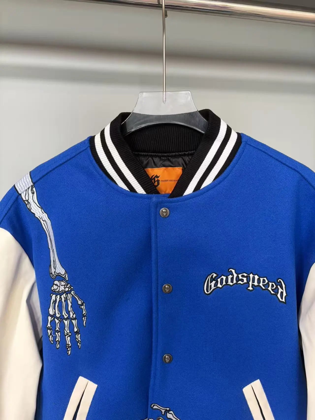 Blue Varsity Jacket with Embroidered Skeleton Design Cream Sleeves