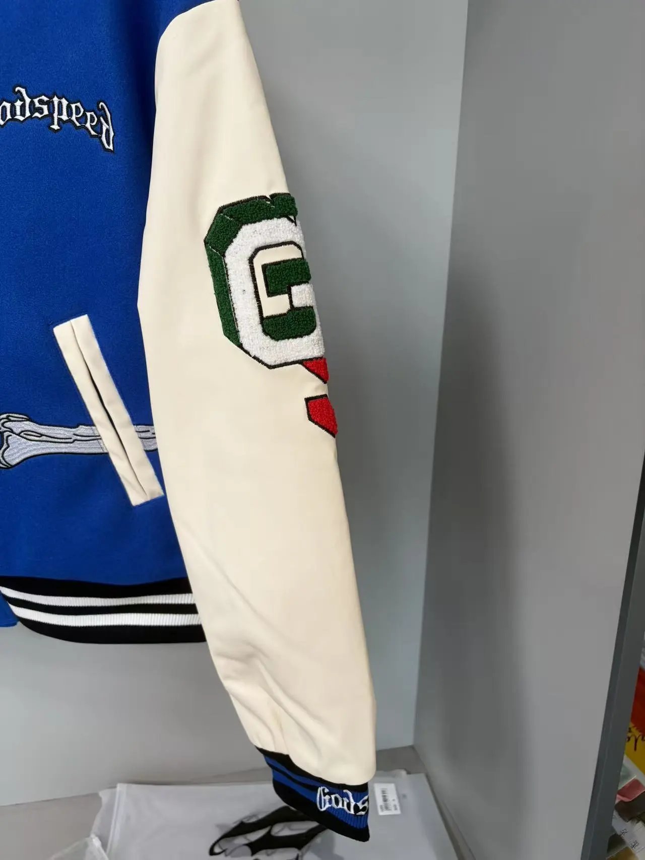 Blue Varsity Jacket with Embroidered Skeleton Design Cream Sleeves