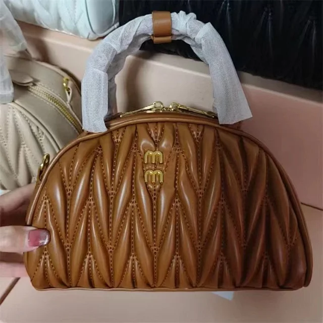 Miu Handbags Quilted semicircle top-handle bag with detachable shoulder strap product detail image 2