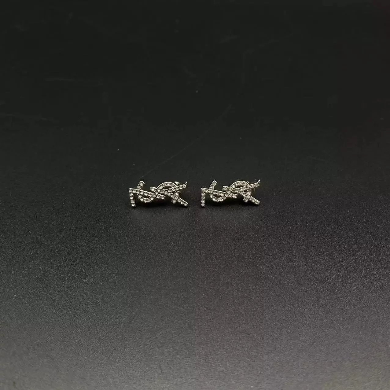 Diamond studded earrings with letter logo style