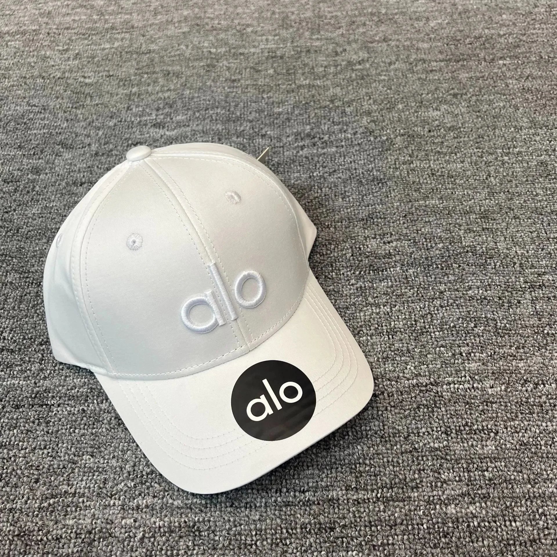 Alo Hats Embroidered Logo Baseball Cap — White embroidery with white letters