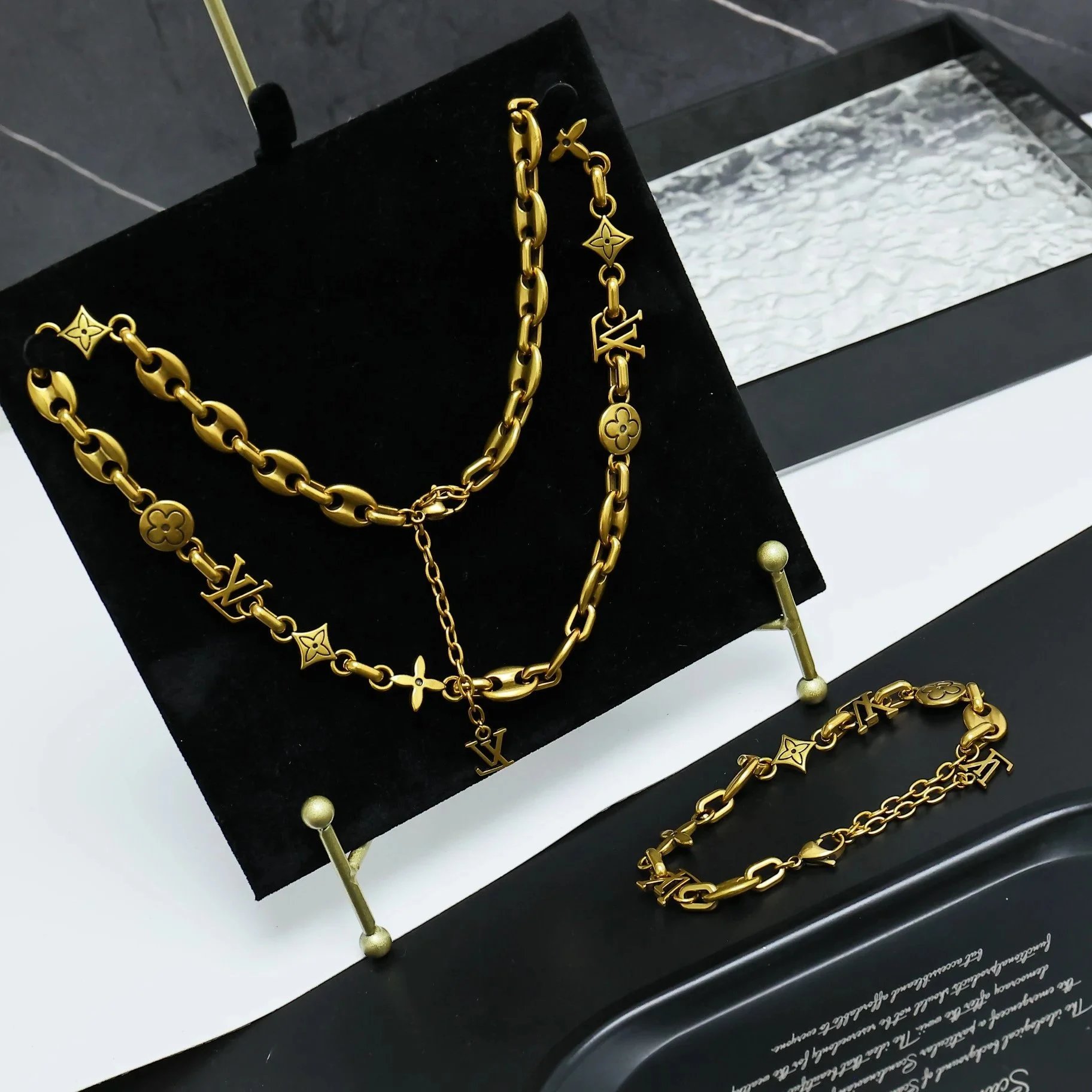 Louis Vuitton Gold-tone chain necklace and bracelet set with monogram motifs