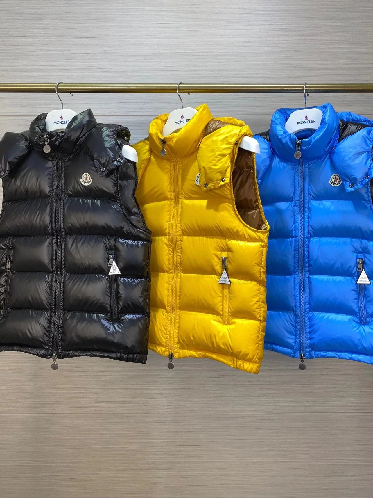 Moncler Black, Yellow, and Blue Puffer Vests