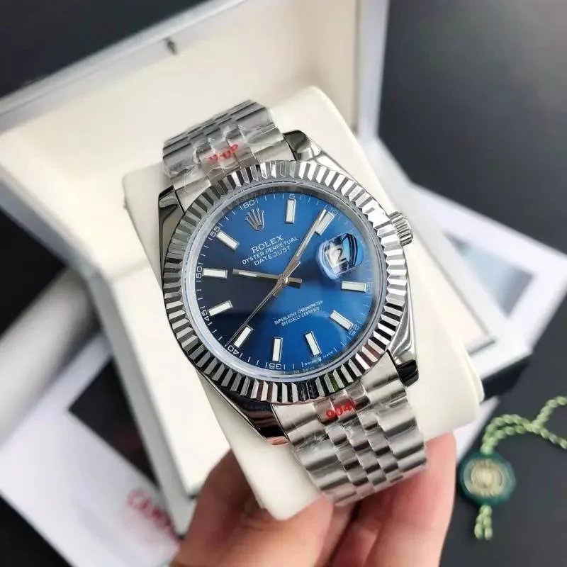 Rolex — Silver case with blue dial, five-link bracelet, and mineral‑strengthened glass. colorway — USFans Spreadsheet photo