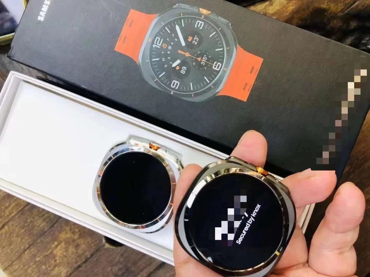 Samsung Smartwatch with orange strap and box