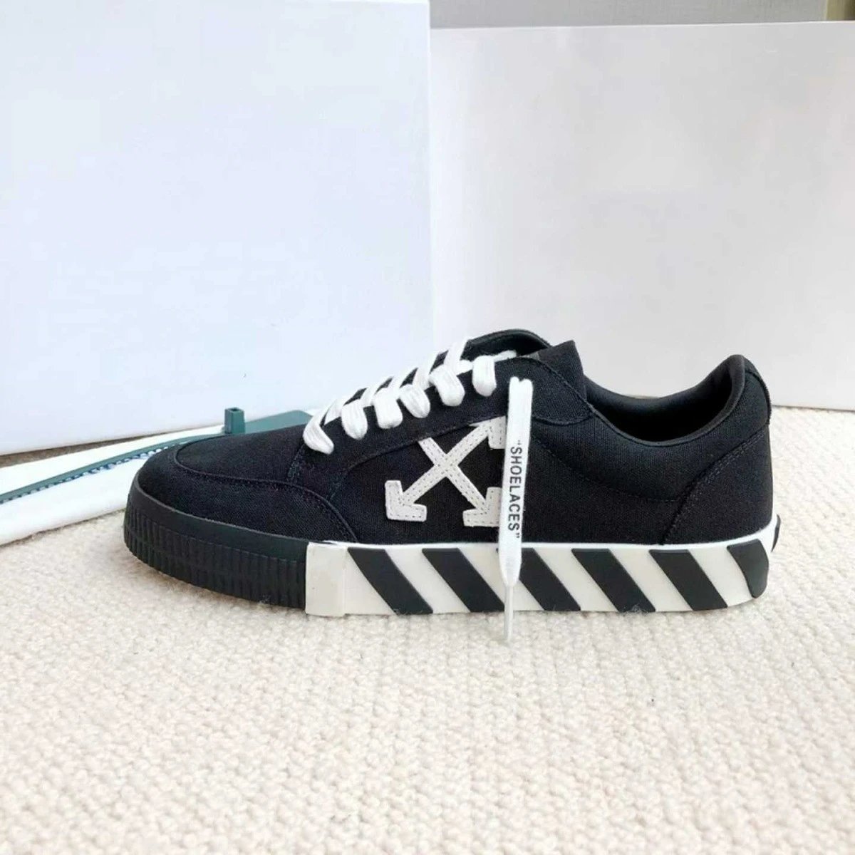 Off-White Sneakers Low-top with crossed-arrow graphic and striped sole — black and white zebra bottom