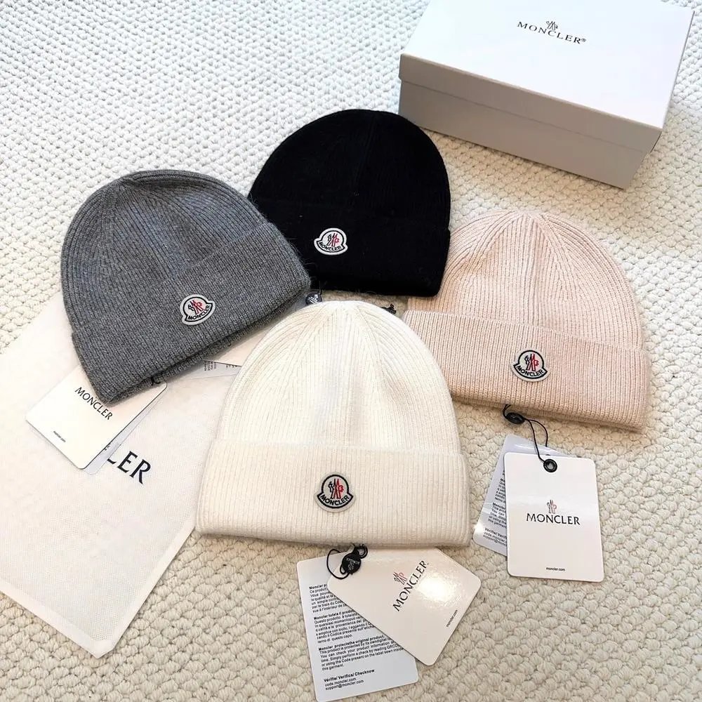 Moncler Hats Logo-patch rib-knit beanie with pom-pom and cable-knit variants image 3