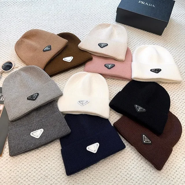 Prada Hats Ribbed knit beanie with triangular logo plaque product detail image 1