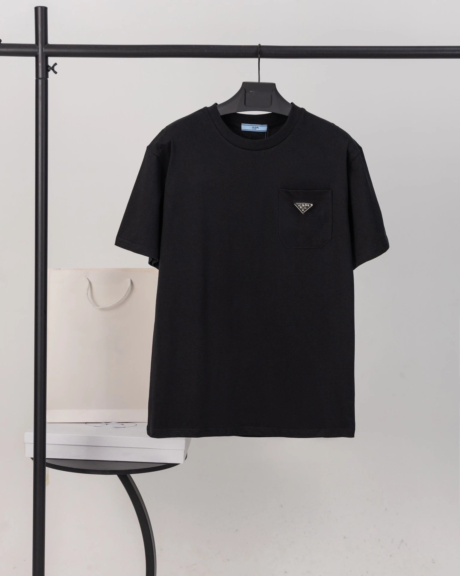 Prada T-Shirts Crew-neck T-shirt with triangular logo plaque — Black triangular-pocket design