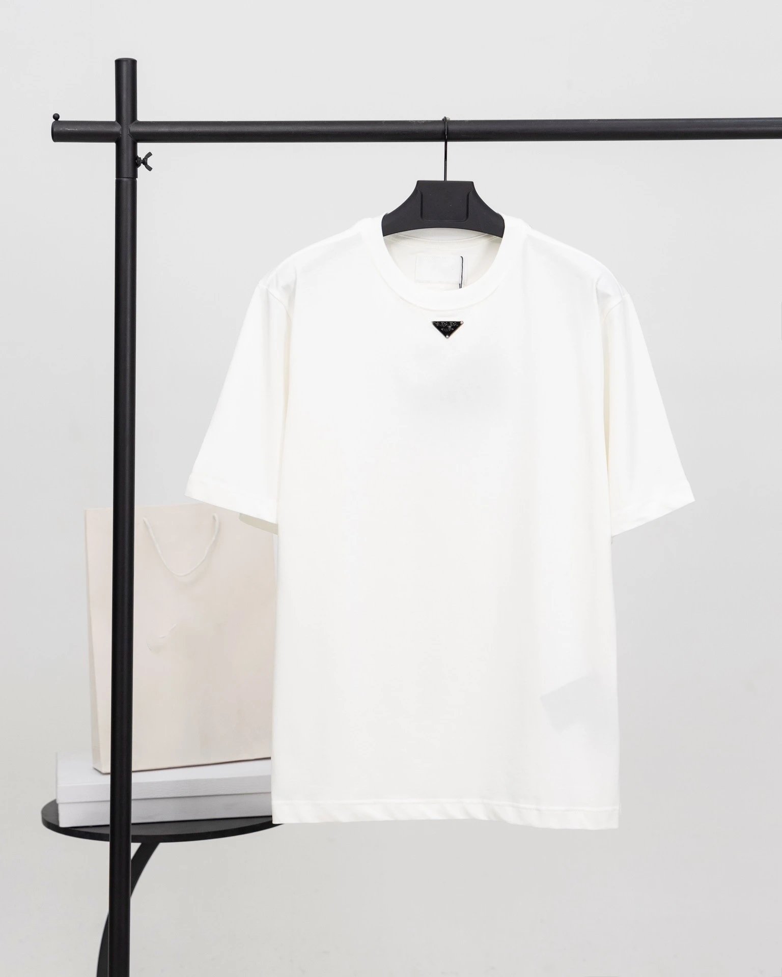 Prada T-Shirts Crew-neck T-shirt with triangular logo plaque — White neckline triangular metal badge