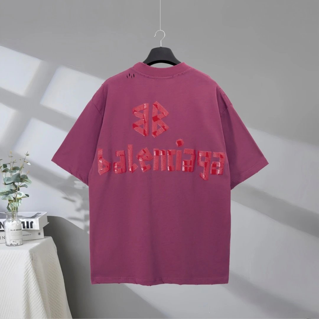 Balenciaga Oversized T-Shirt in Purple, featuring bold red logo lettering, premium cotton fabric, casual street style, perfect for daily wear or fashion-forward looks.
