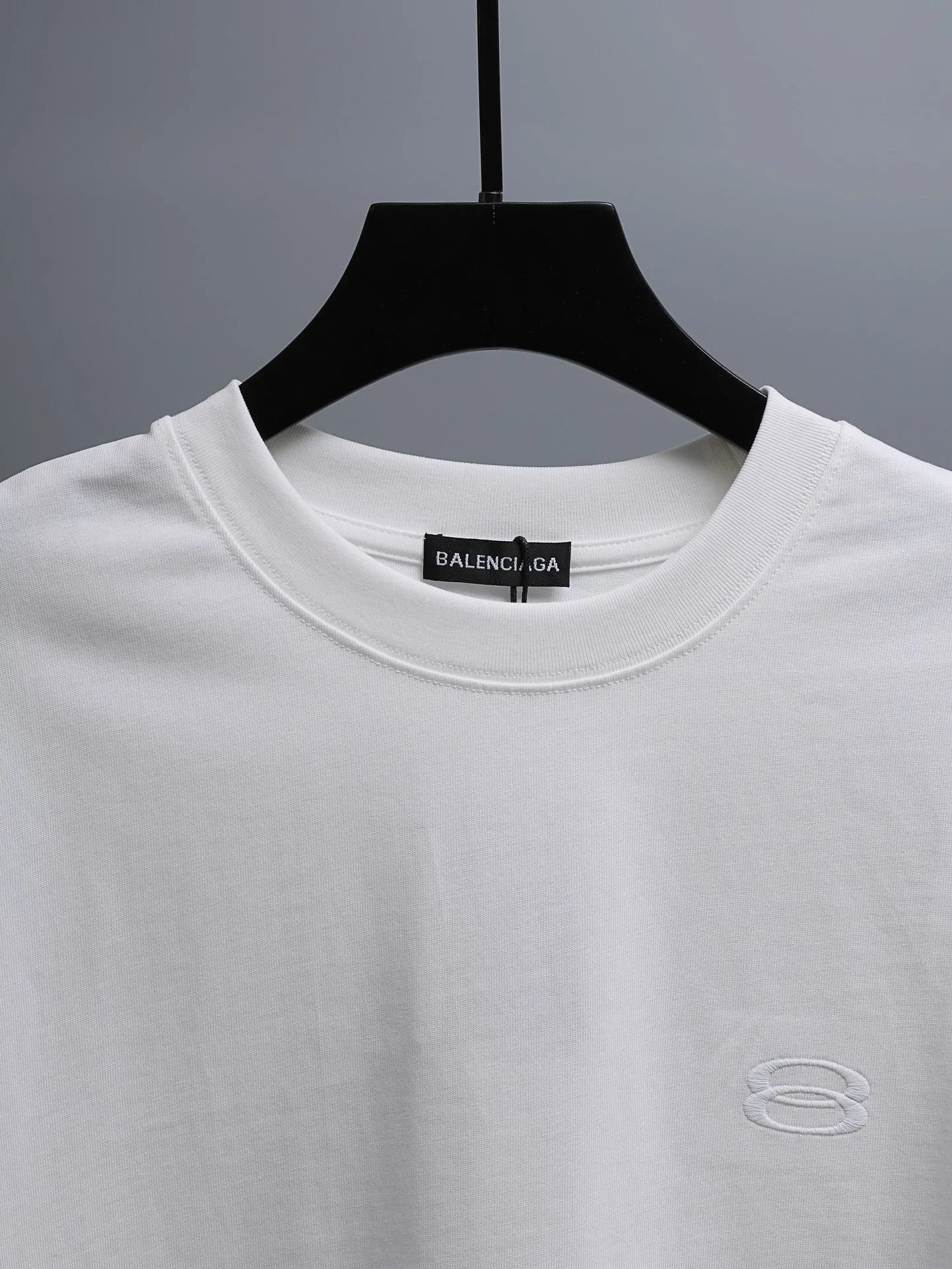Balenciaga Men's White Cotton T-Shirt, minimalist design with logo detail, soft and breathable fabric, perfect for casual or street style outfits.