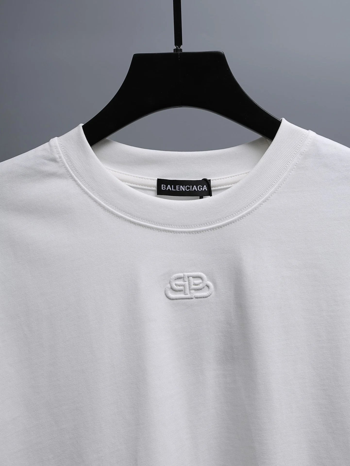 BALENCIAGA White Cotton T-Shirt, minimalist design with embroidered logo, soft breathable fabric for daily wear, perfect premium fashion top for casual or street style outfits.