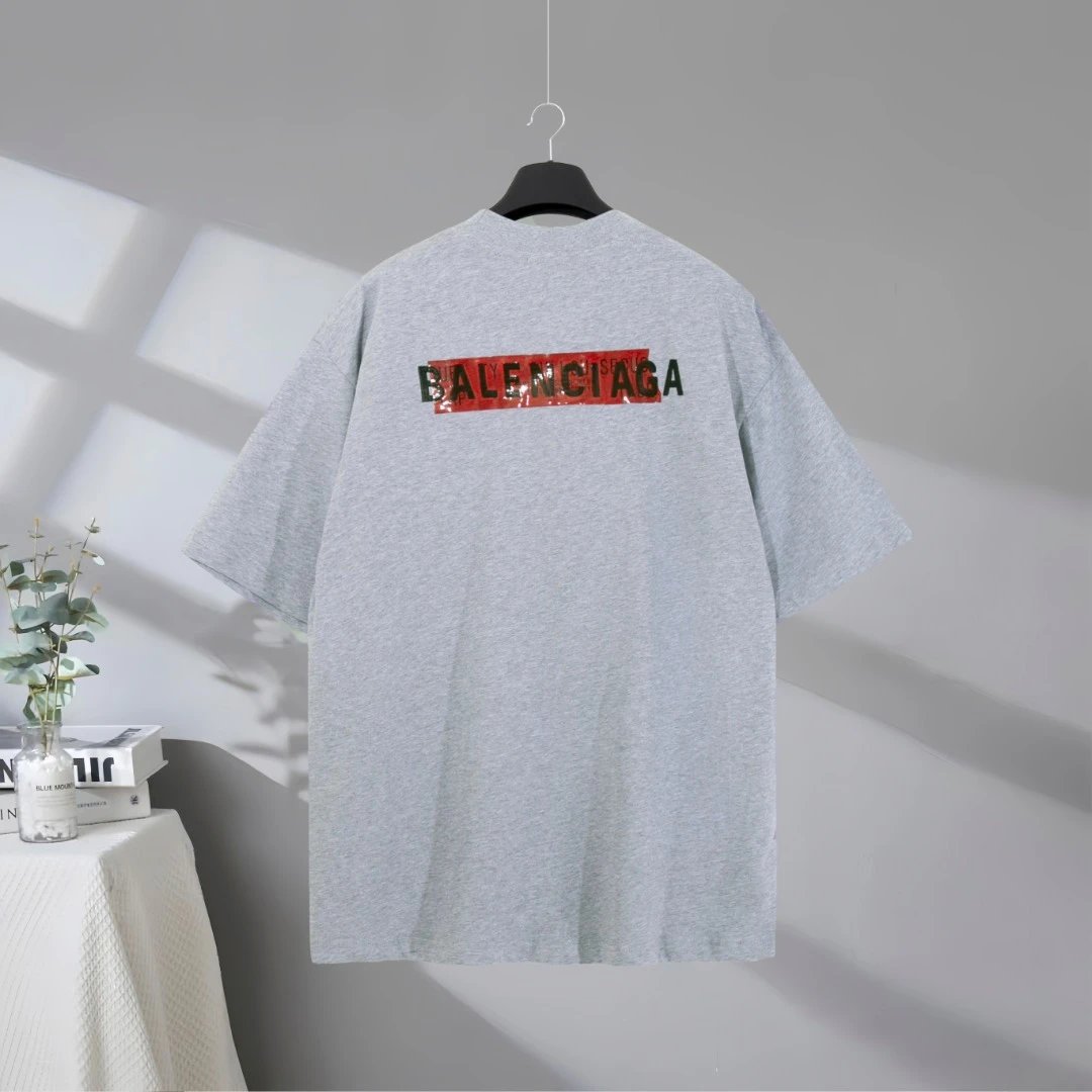 Balenciaga Men's Oversized Grey Cotton T-Shirt, minimalist design with red printed logo, casual streetwear fashion, comfortable and stylish top for daily wear.