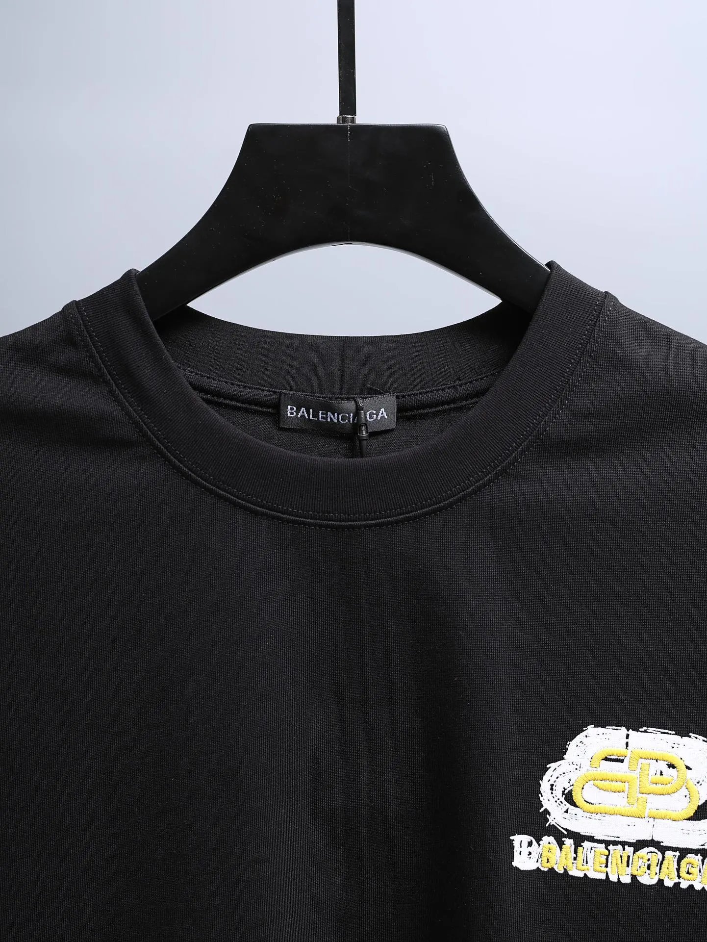 Balenciaga Men's Black Cotton T-Shirt, featuring a modern logo design on the chest, short sleeves, and a relaxed fit for everyday streetwear or casual fashion style.