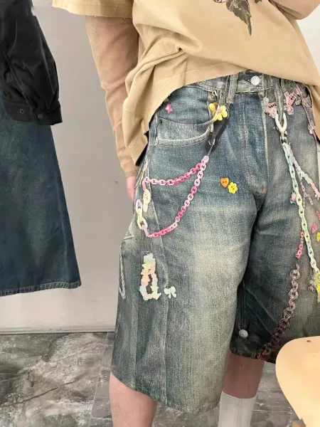 Design Custom Embellished Denim Shorts with Chain and Floral Appliqués - 1