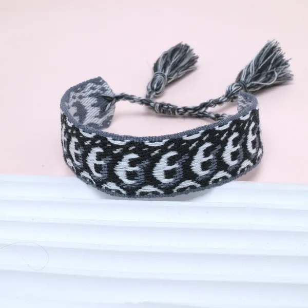 Handwoven Patterned Tassel Bracelet in Charcoal Gray and White - 1