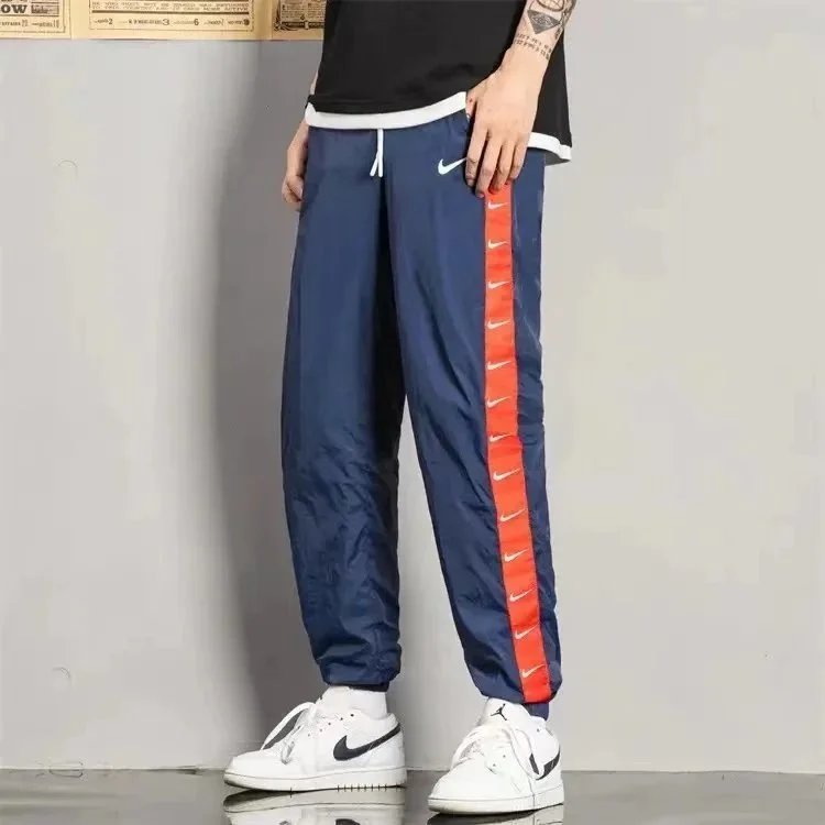 Nike Trousers Tapered running with zip pockets and reflective details — 27