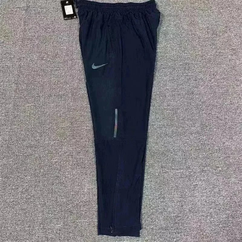 Nike Trousers Tapered running with zip pockets and reflective details — 10 Royal blue
