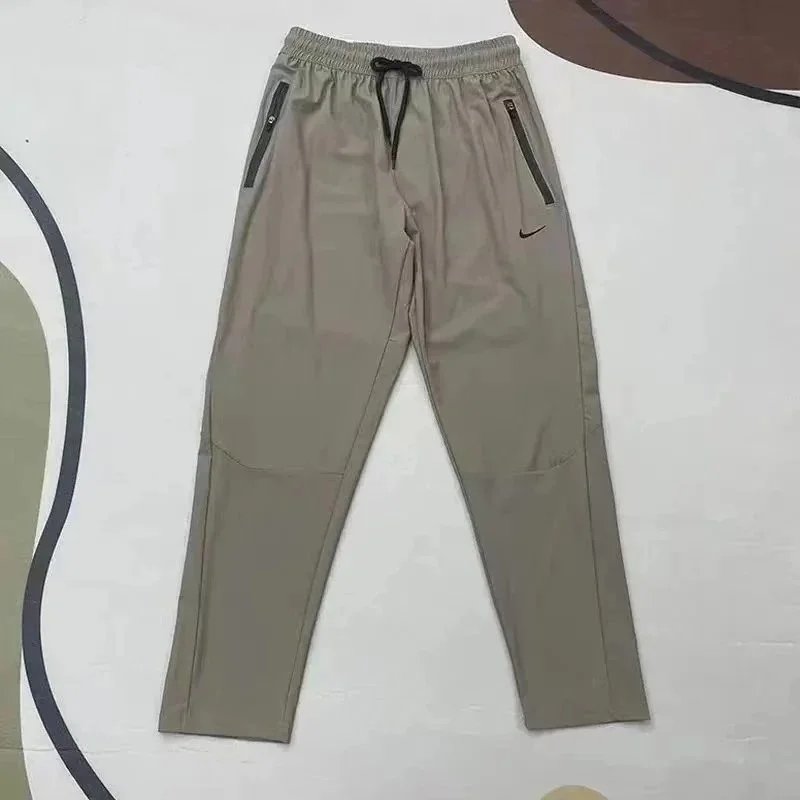 Nike Trousers Tapered running with zip pockets and reflective details — 29