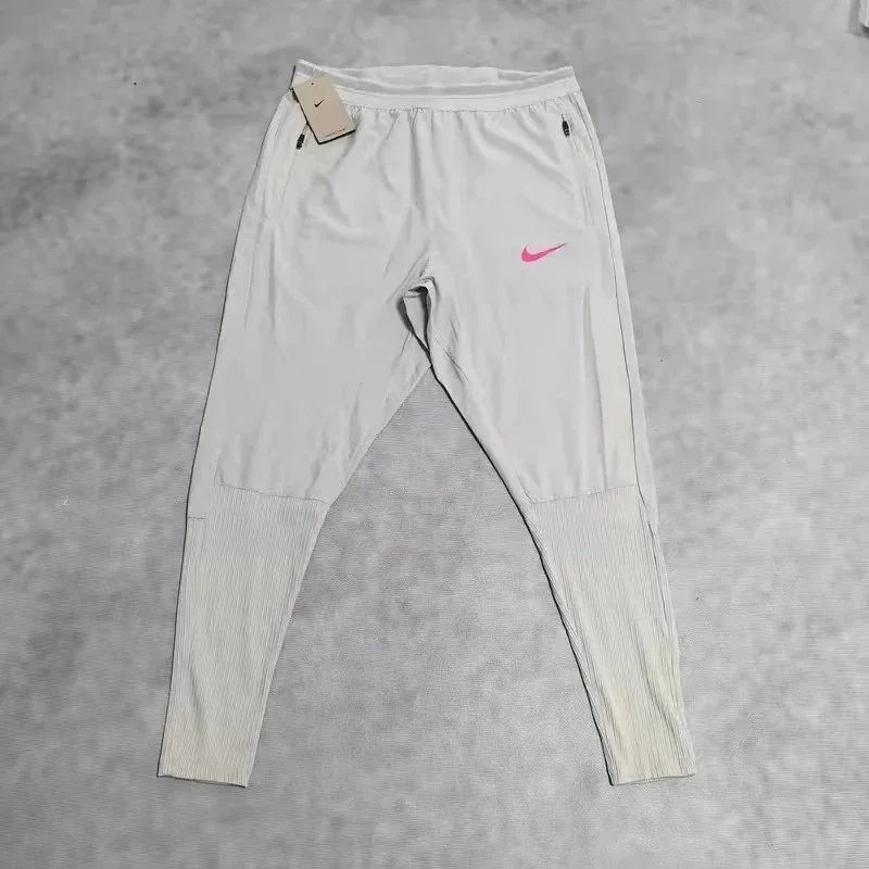 Nike Trousers Tapered running with zip pockets and reflective details — 26