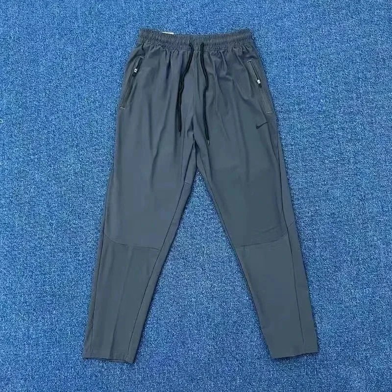 Nike Trousers Tapered running with zip pockets and reflective details — 11
