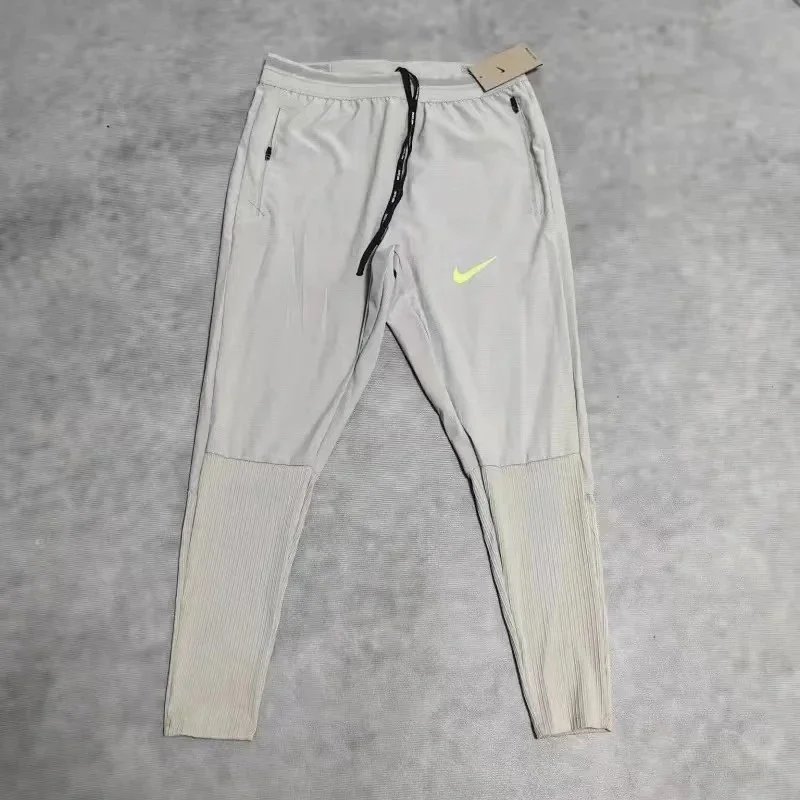 Nike Trousers Tapered running with zip pockets and reflective details — 38