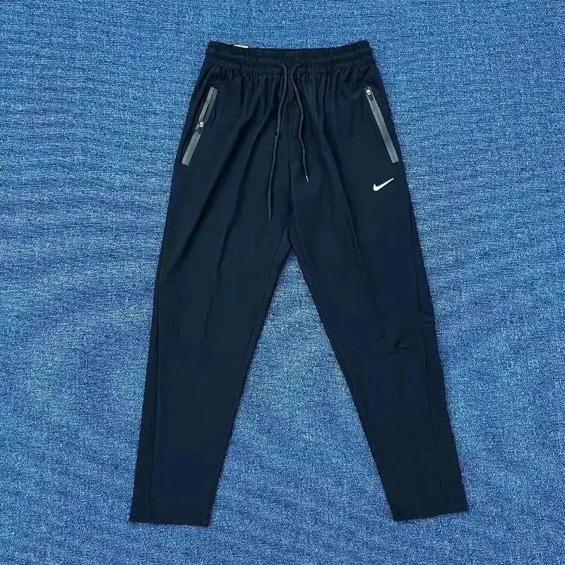 Nike Trousers Tapered running with zip pockets and reflective details — 25