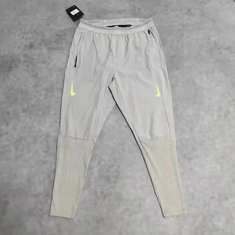 Nike Trousers Tapered running with zip pockets and reflective details — 33