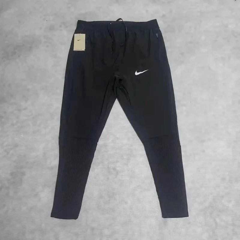 Nike Trousers Tapered running with zip pockets and reflective details — 37