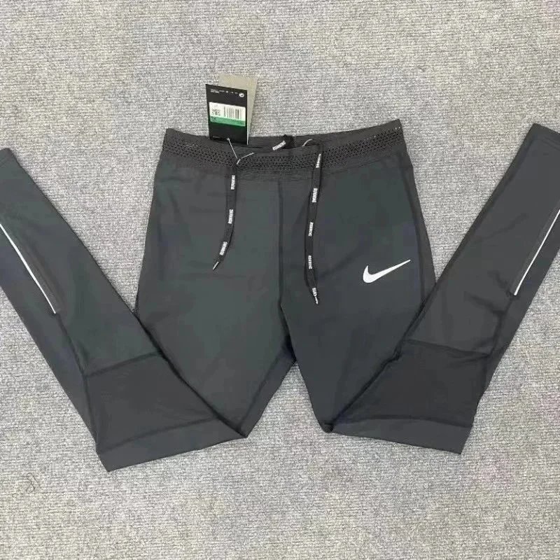 Nike Trousers Tapered running with zip pockets and reflective details — 16