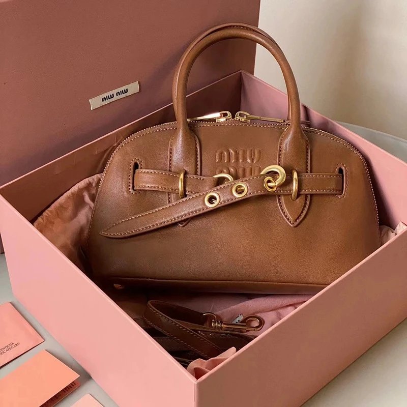 Miu Handbags Dome handbag with belt-style gold-tone hardware and detachable shoulder strap — Brown
