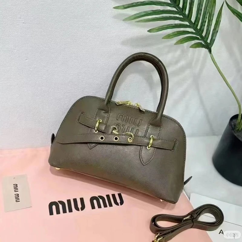 Miu Handbags Dome handbag with belt-style gold-tone hardware and detachable shoulder strap — Gray-brown
