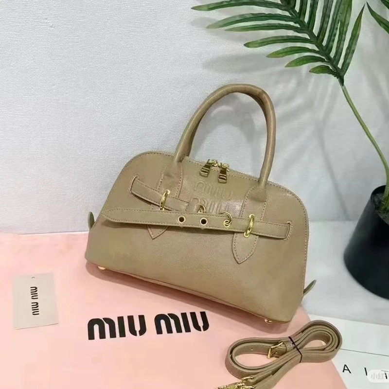 Miu Handbags Dome handbag with belt-style gold-tone hardware and detachable shoulder strap — Apricot color