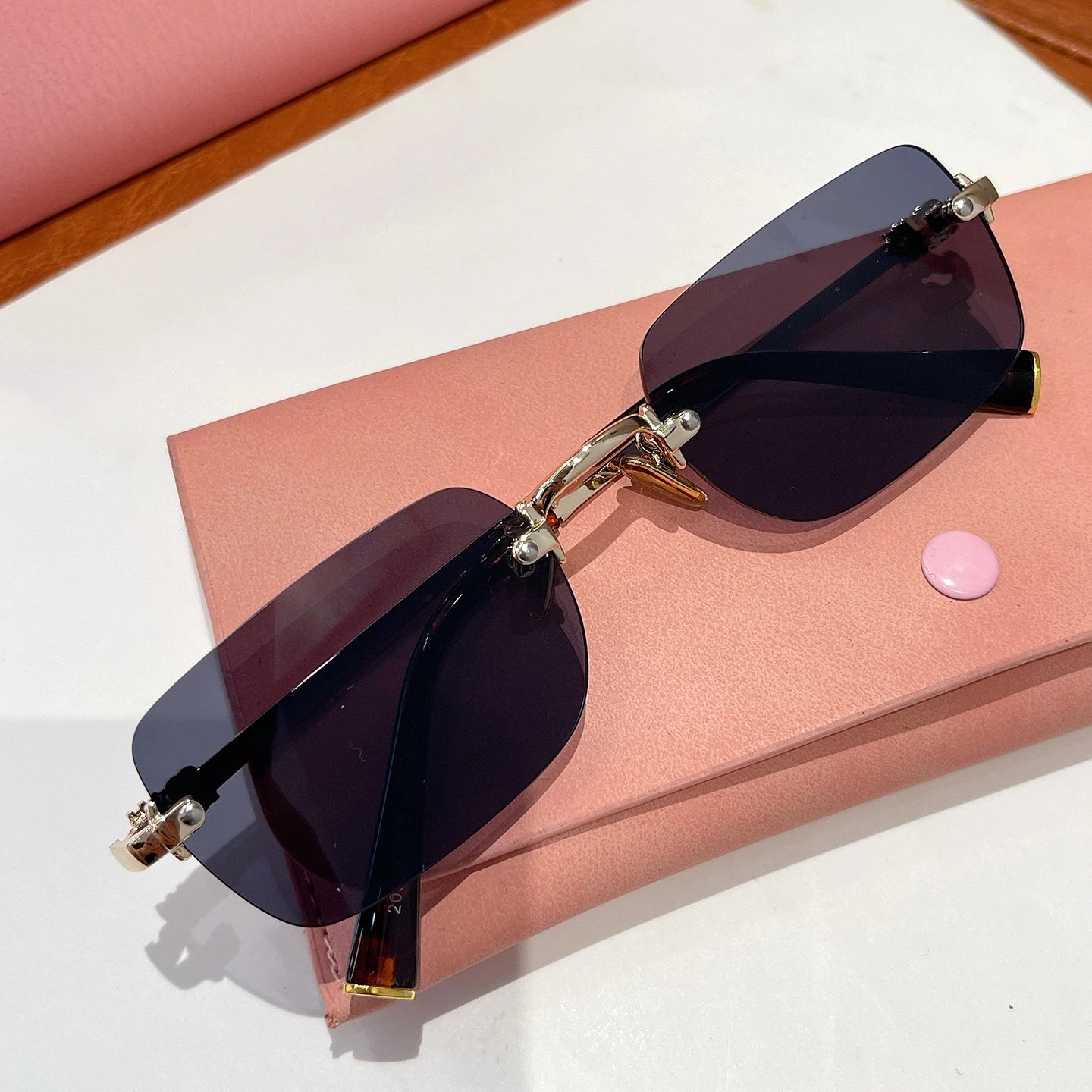 Miu Eyewear Rimless rectangular sunglasses — Golden gray
