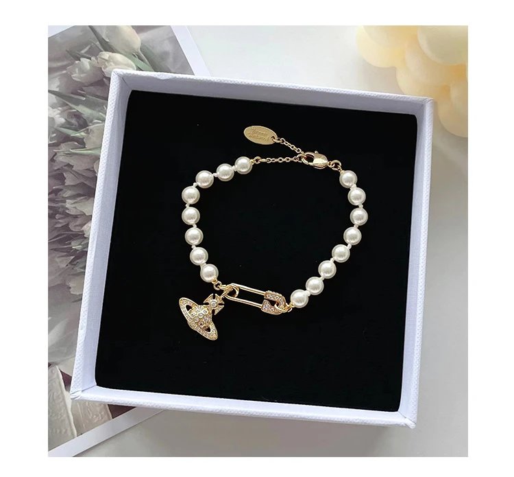 Unbranded Jewelry Orb and Cross Pendant Necklace — Pearl brooch bracelet (gold color)