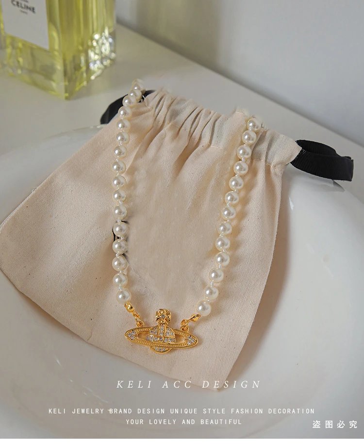 Unbranded Jewelry Orb and Cross Pendant Necklace — Pearl Saturn necklace (gold), with an extender.